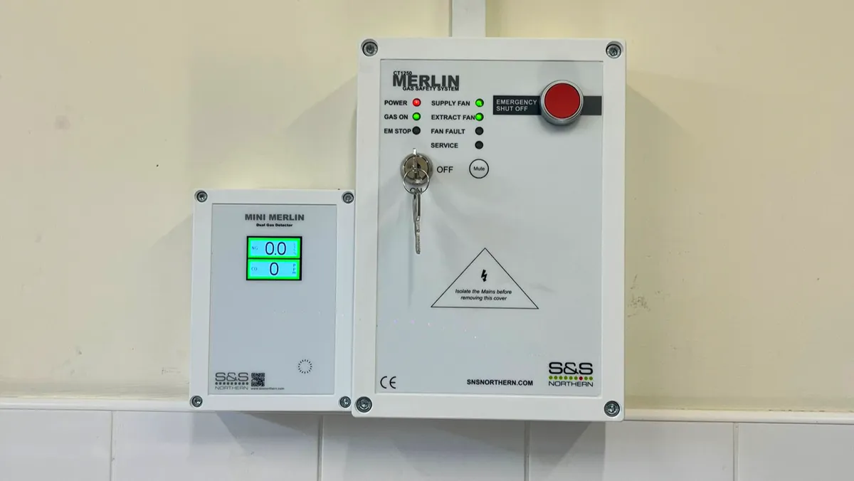 S&S Northern Merlin gas safety panel with emergency shut-off button, next to a Mini Merlin gas detector