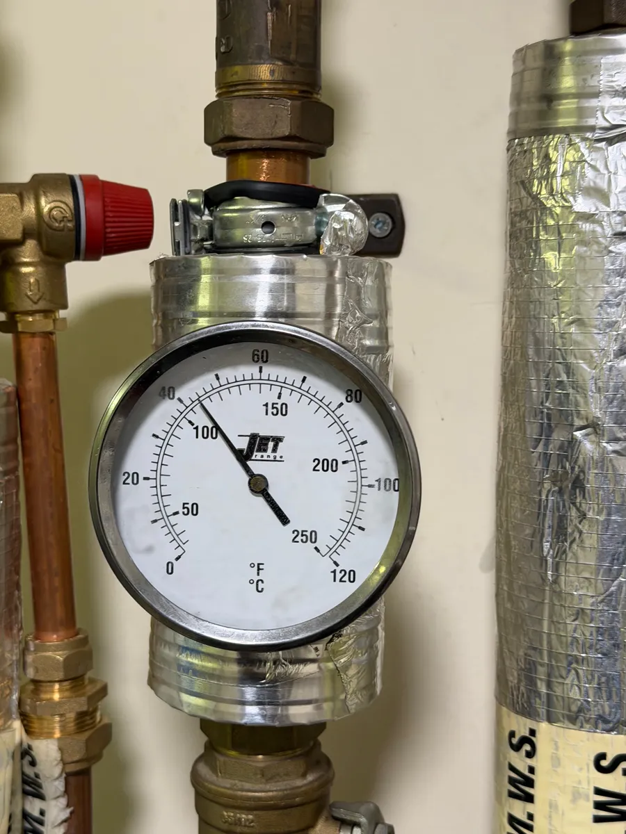 Temperature gauge and safety valve on heating pipework, Walton Summit, Preston