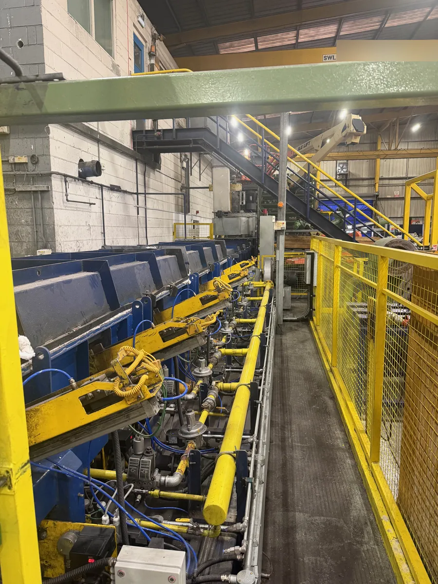 Row of burner gas trains with valves and regulators along a process line, Wigan